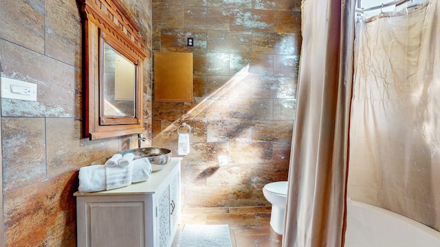 full bathroom with shower / bath combination with curtain, toilet, and sink