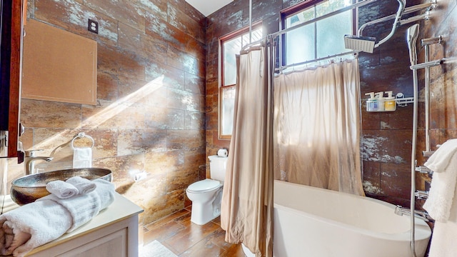 full bathroom with vanity, wood-type flooring, shower / tub combo, and toilet