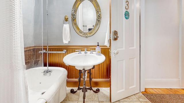 bathroom with tile patterned flooring and a bathtub