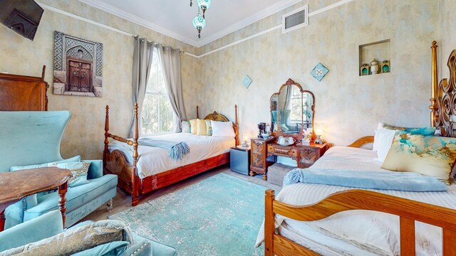 bedroom featuring hardwood / wood-style flooring and crown molding