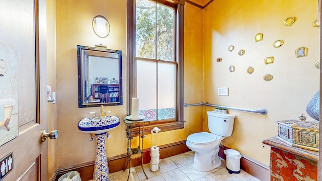 bathroom with sink, tile patterned flooring, and toilet