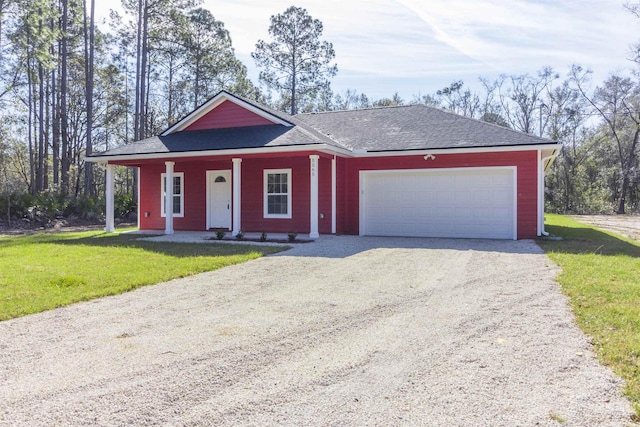 view of front of property featuring a front yard and a garage