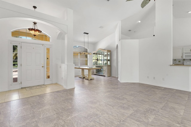 546 Sevilla Dr, Saint Augustine, FL 32086 - entrance foyer featuring high vaulted ceiling, a chandelier, and arched walkways