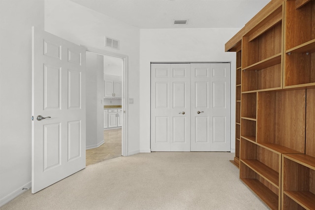 546 Sevilla Dr, Saint Augustine, FL 32086 - unfurnished bedroom featuring light carpet and a closet