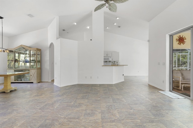 546 Sevilla Dr, Saint Augustine, FL 32086 - unfurnished living room featuring arched walkways, high vaulted ceiling, and ceiling fan