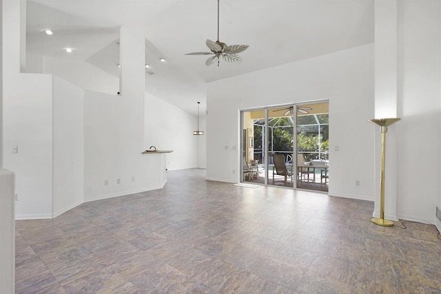 546 Sevilla Dr, Saint Augustine, FL 32086 - unfurnished living room with ceiling fan, high vaulted ceiling, stone finish floors, and a sunroom