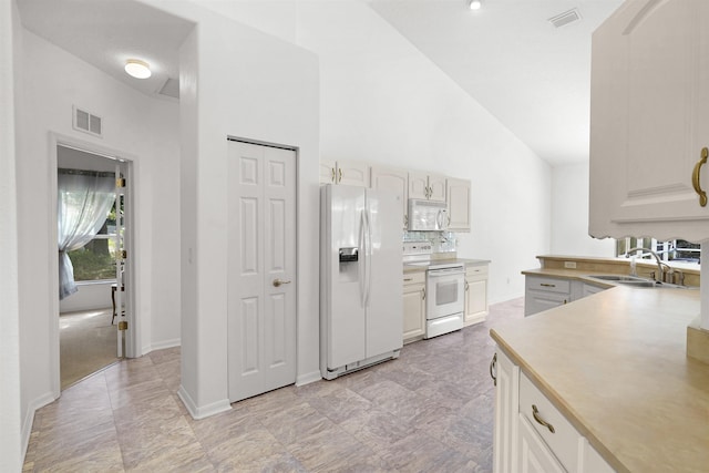 546 Sevilla Dr, Saint Augustine, FL 32086 - kitchen with white appliances, high vaulted ceiling, and light countertops