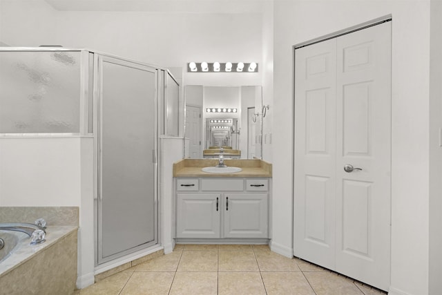 546 Sevilla Dr, Saint Augustine, FL 32086 - bathroom featuring a shower stall, tile patterned floors, a bath, vanity, and a closet