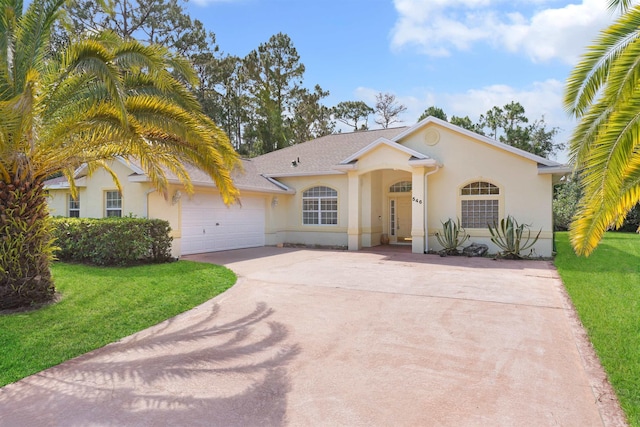 546 Sevilla Dr, Saint Augustine, FL 32086 - view of front of house featuring driveway, stucco siding, a front lawn, and a garage