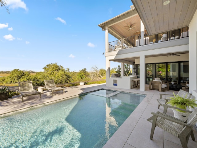 view of pool featuring a bar, a patio, and ceiling fan