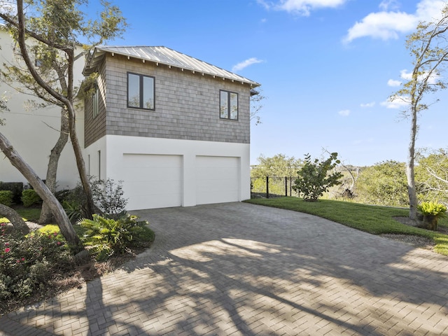 view of home's exterior featuring a garage and a yard