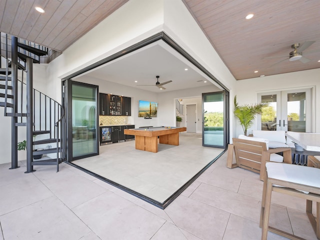 interior space featuring an outdoor living space, ceiling fan, and french doors