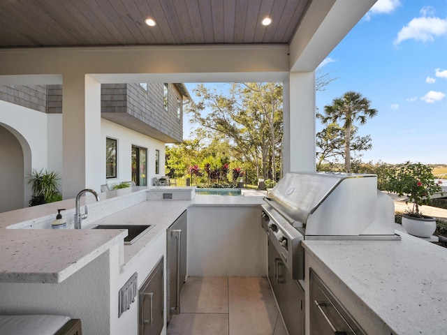 view of patio / terrace with area for grilling and sink