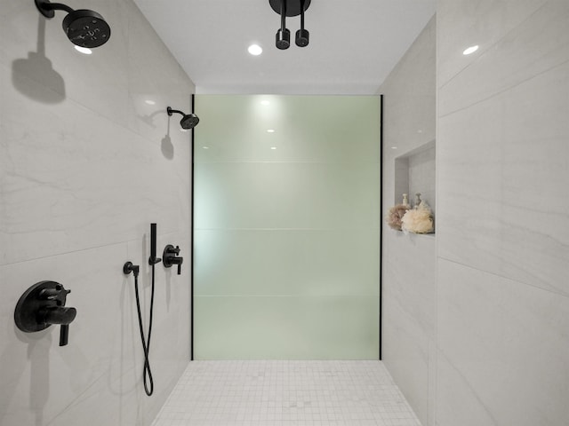 bathroom with tile patterned floors and tiled shower