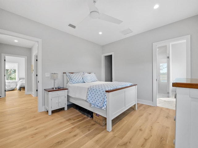 bedroom with ceiling fan, light hardwood / wood-style flooring, and ensuite bath