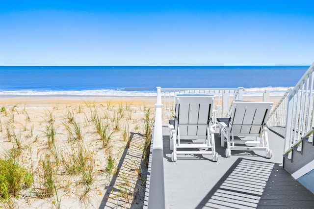 exterior space featuring a water view and a view of the beach