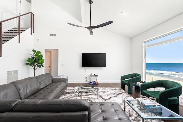 living area featuring visible vents, baseboards, wood finished floors, and a ceiling fan