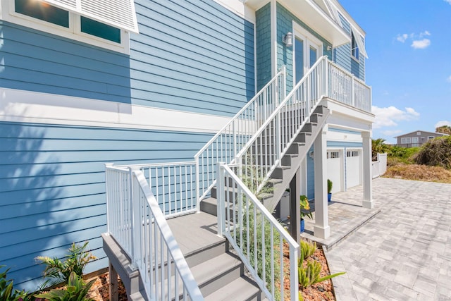 property entrance featuring an attached garage and driveway
