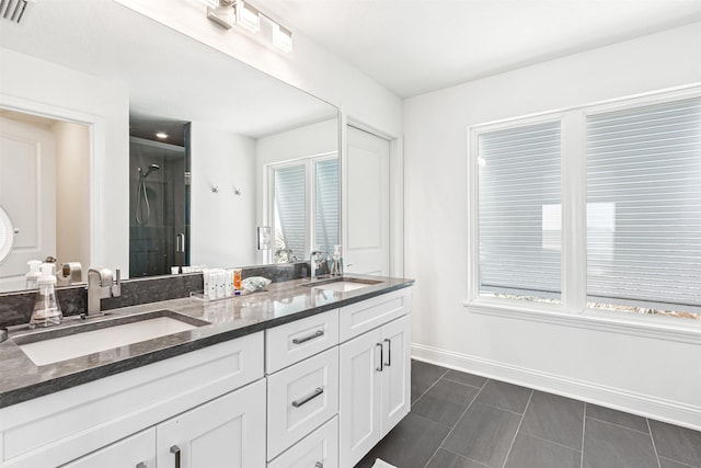 full bathroom with a sink, visible vents, baseboards, and a stall shower