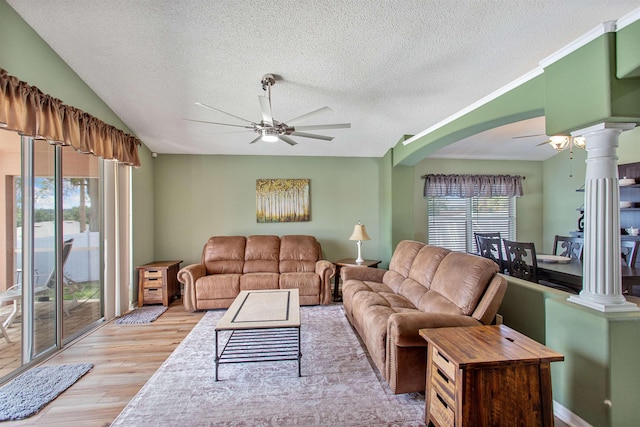 1505 Sundown Ln, Clermont, FL 34711 - living room with a ceiling fan, a textured ceiling, light wood-style floors, ornate columns, and arched walkways