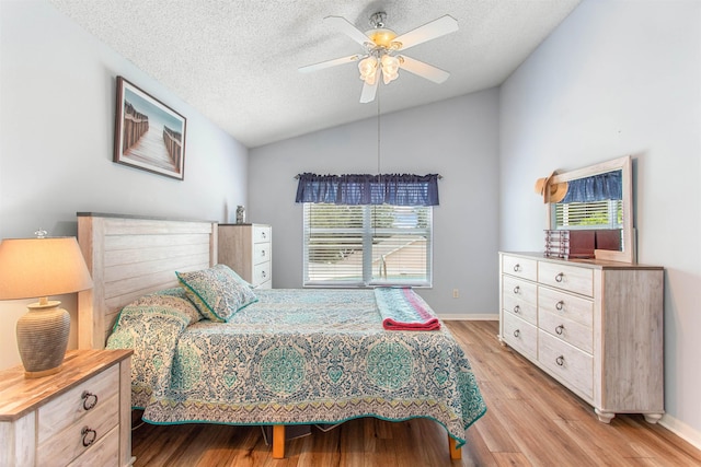 1505 Sundown Ln, Clermont, FL 34711 - bedroom featuring vaulted ceiling, light wood-type flooring, a textured ceiling, baseboards, and ceiling fan