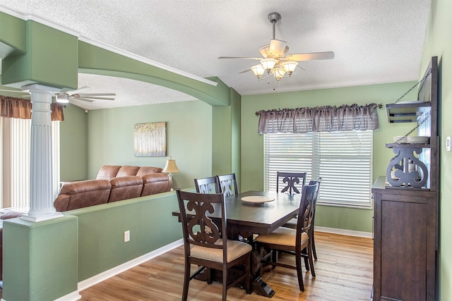 1505 Sundown Ln, Clermont, FL 34711 - dining room with a ceiling fan, decorative columns, a textured ceiling, and light wood finished floors