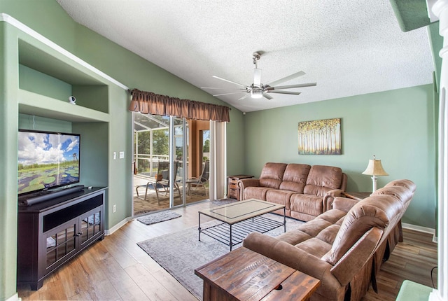 1505 Sundown Ln, Clermont, FL 34711 - living area with a ceiling fan, a textured ceiling, vaulted ceiling, light wood finished floors, and baseboards