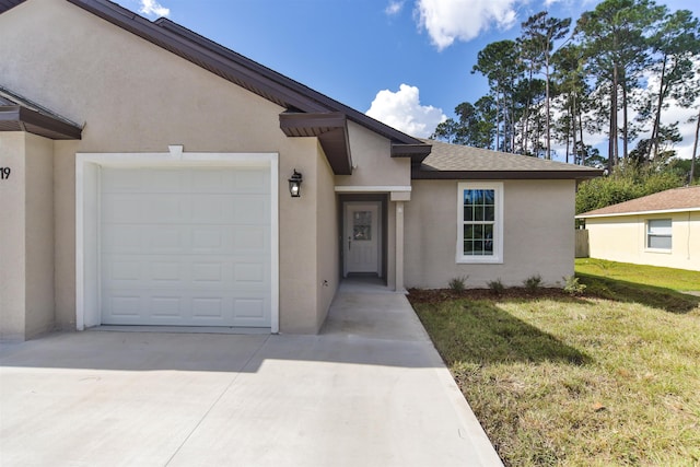 view of front of property with a front lawn and a garage