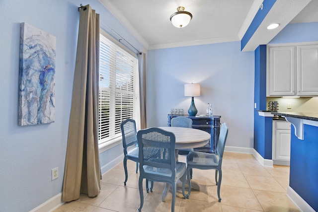 dining area featuring light tile patterned floors and ornamental molding