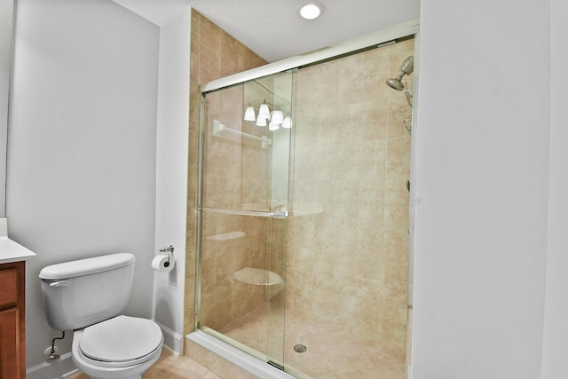 bathroom with vanity, tile patterned flooring, toilet, a textured ceiling, and an enclosed shower