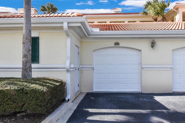 view of exterior entry with a garage