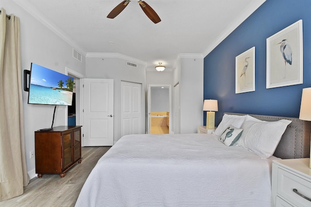 bedroom with ceiling fan, ornamental molding, connected bathroom, and light hardwood / wood-style flooring