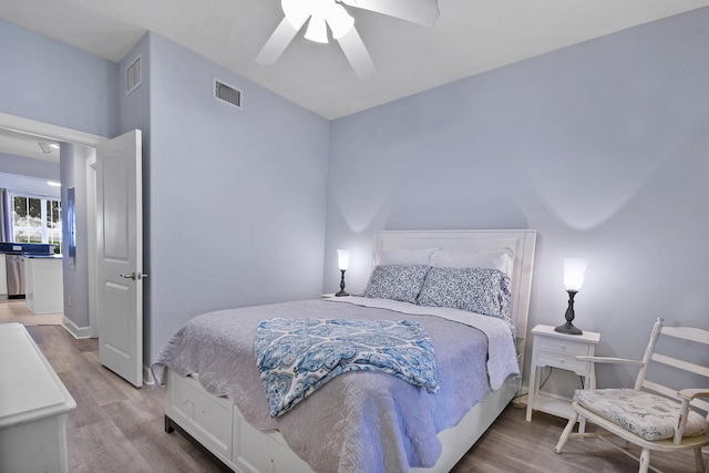 bedroom with hardwood / wood-style flooring and ceiling fan