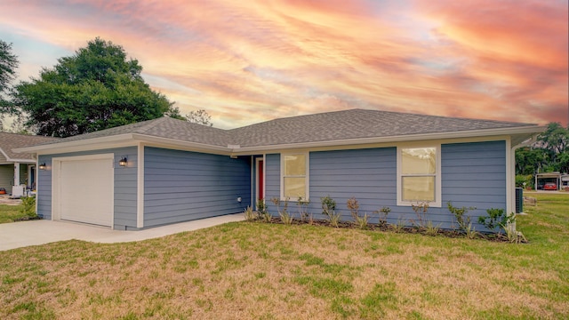 ranch-style house with a lawn and a garage