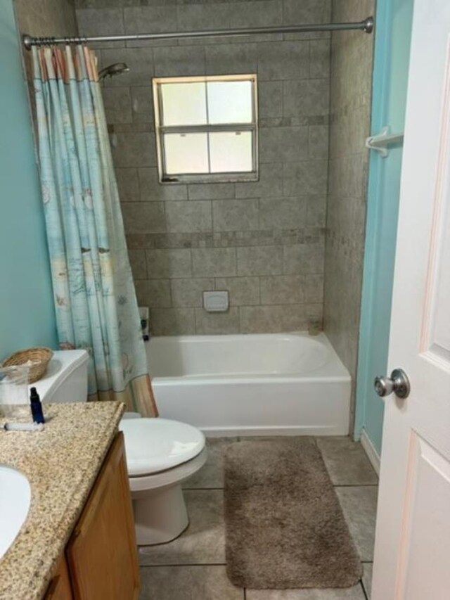 full bathroom featuring tile patterned floors, vanity, shower / bath combination with curtain, and toilet