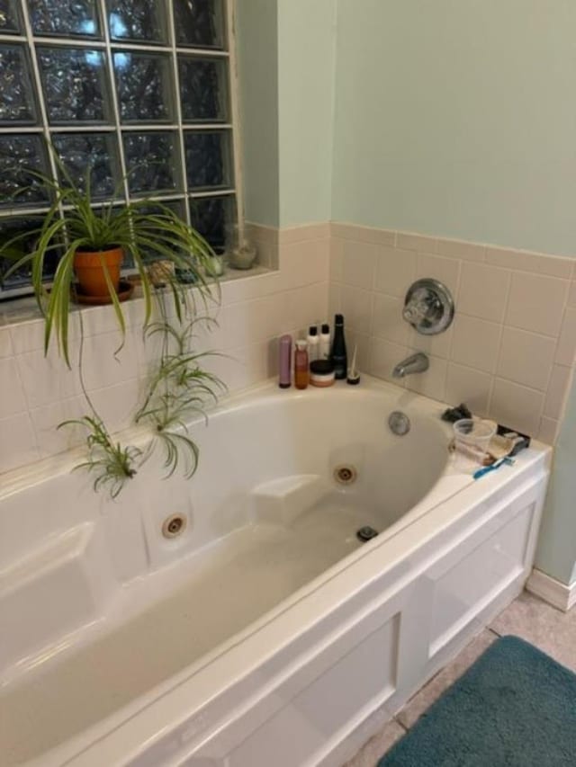 bathroom with a bathing tub and tile patterned flooring