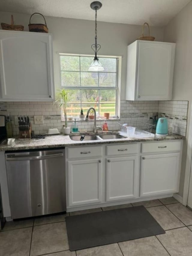 kitchen with dishwasher, white cabinets, hanging light fixtures, and sink