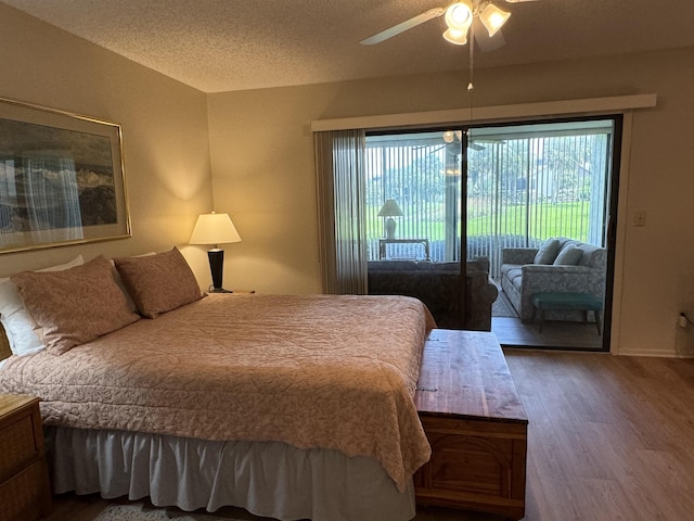 bedroom featuring ceiling fan, hardwood / wood-style floors, access to outside, and a textured ceiling