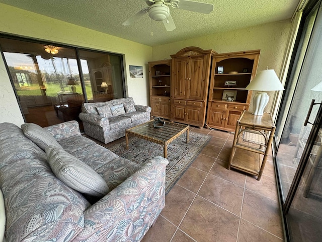 tiled living room with ceiling fan and a textured ceiling