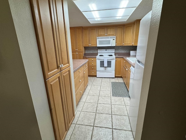 kitchen with backsplash and white appliances