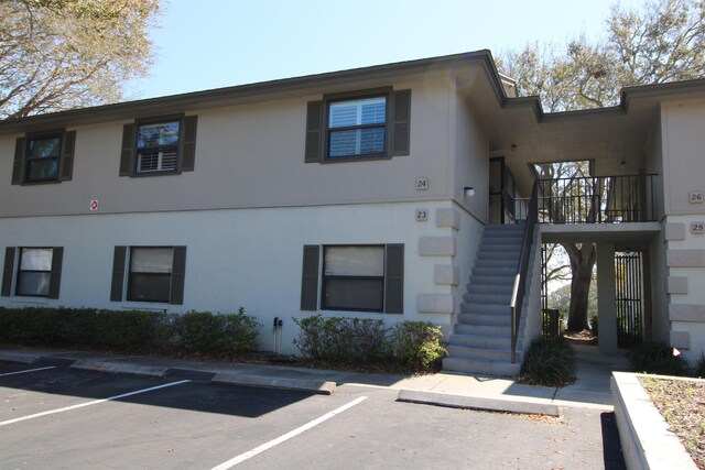 24 Aledo Ct, Saint Augustine, FL 32086 - view of building exterior with stairs and uncovered parking