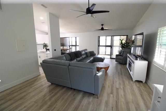 24 Aledo Ct, Saint Augustine, FL 32086 - living room with lofted ceiling, light wood finished floors, visible vents, and baseboards
