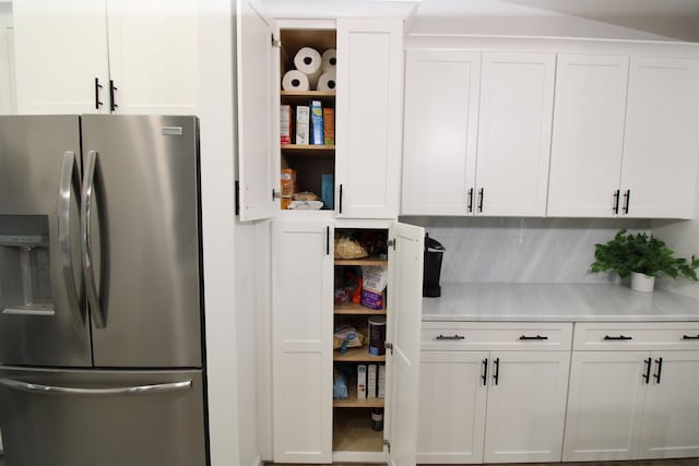 24 Aledo Ct, Saint Augustine, FL 32086 - interior space featuring light countertops, white cabinets, stainless steel refrigerator with ice dispenser, and open shelves
