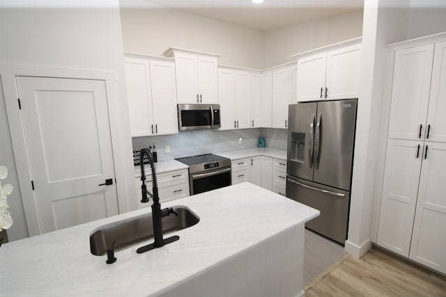 24 Aledo Ct, Saint Augustine, FL 32086 - kitchen with stainless steel appliances, light countertops, a sink, and white cabinetry