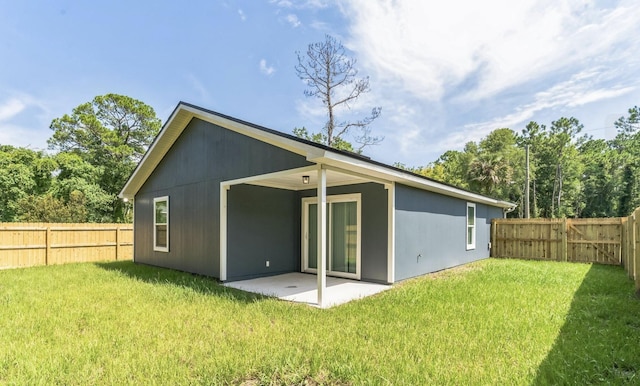 back of property featuring a yard and a patio