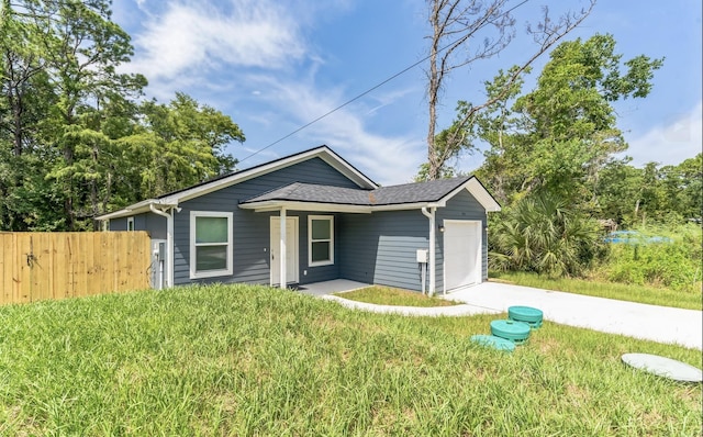 single story home featuring a front yard and a garage