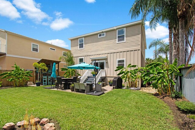 13 Court Edna, Saint Augustine, FL 32084 - back of house with board and batten siding and a patio area