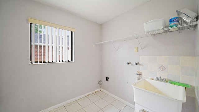 90 Wellshire Ln, Palm Coast, FL 32164 - washroom with laundry area, baseboards, a sink, washer hookup, and light tile patterned floors
