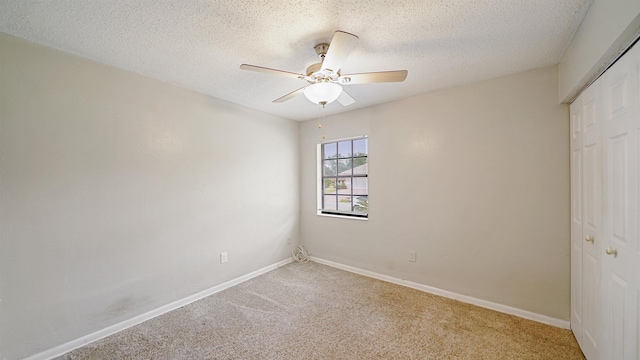 90 Wellshire Ln, Palm Coast, FL 32164 - unfurnished bedroom featuring a closet, a textured ceiling, baseboards, and carpet floors