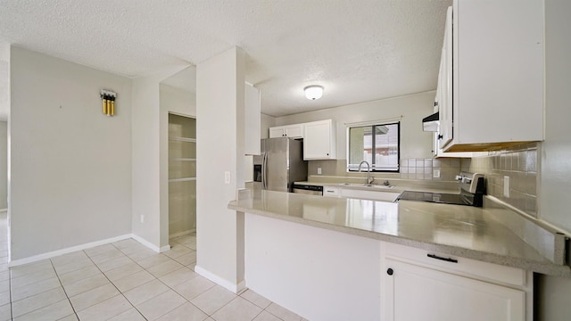 90 Wellshire Ln, Palm Coast, FL 32164 - kitchen featuring exhaust hood, stainless steel appliances, a textured ceiling, and a sink